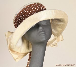 Sallita cream silk hat trimmed with chocolate and white polka dot rose and silk bow
