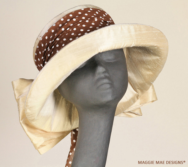 Sallita cream silk hat trimmed with chocolate and white polka dot rose and silk bow