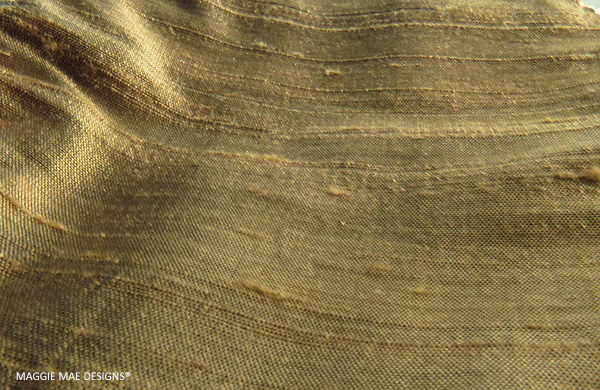 A brassy chocolate silk dupioni was used to create the inner lining of the "Piper" fascinator  by MAGGIE MAE DESIGNS